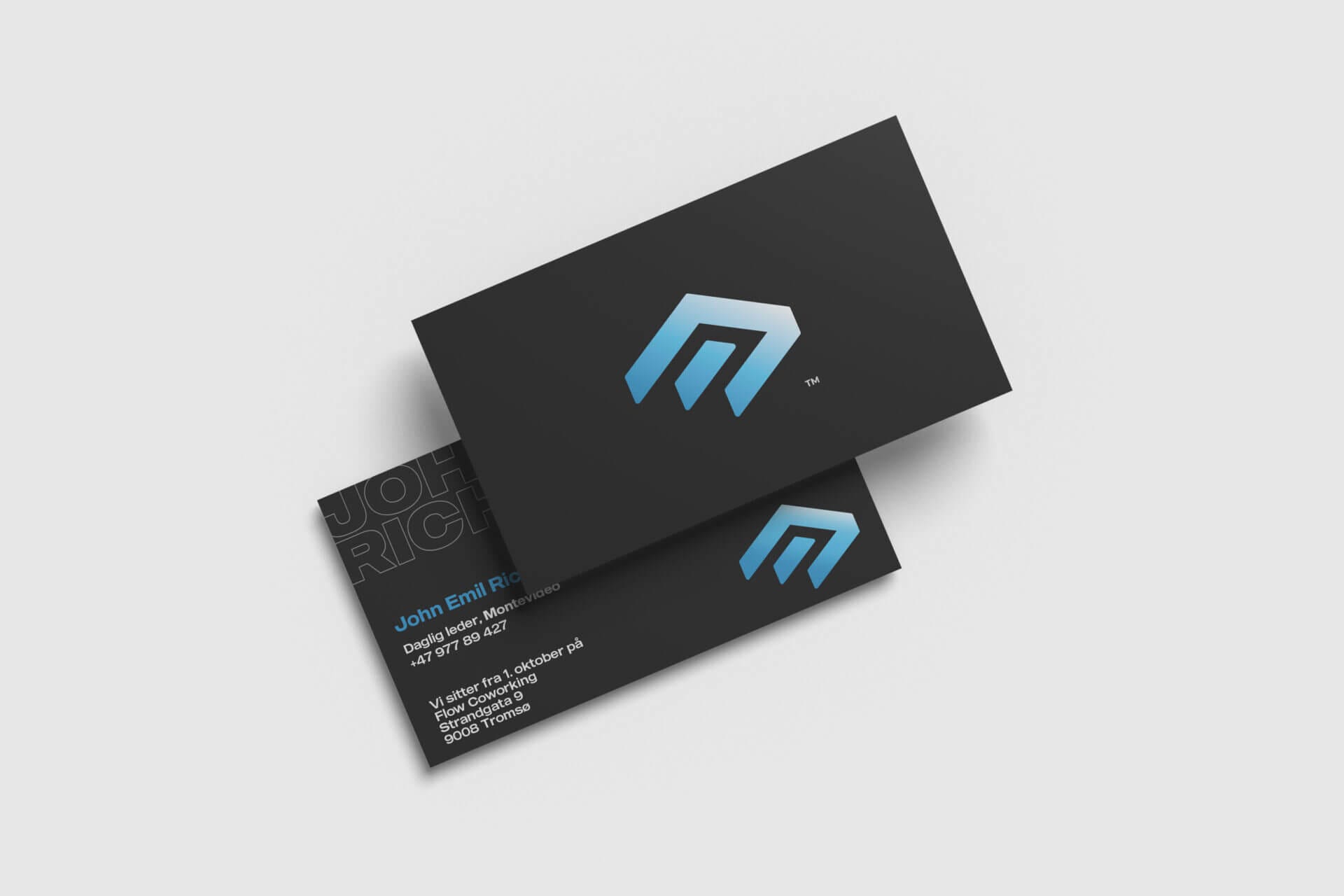 A black business card with a blue logo on it.