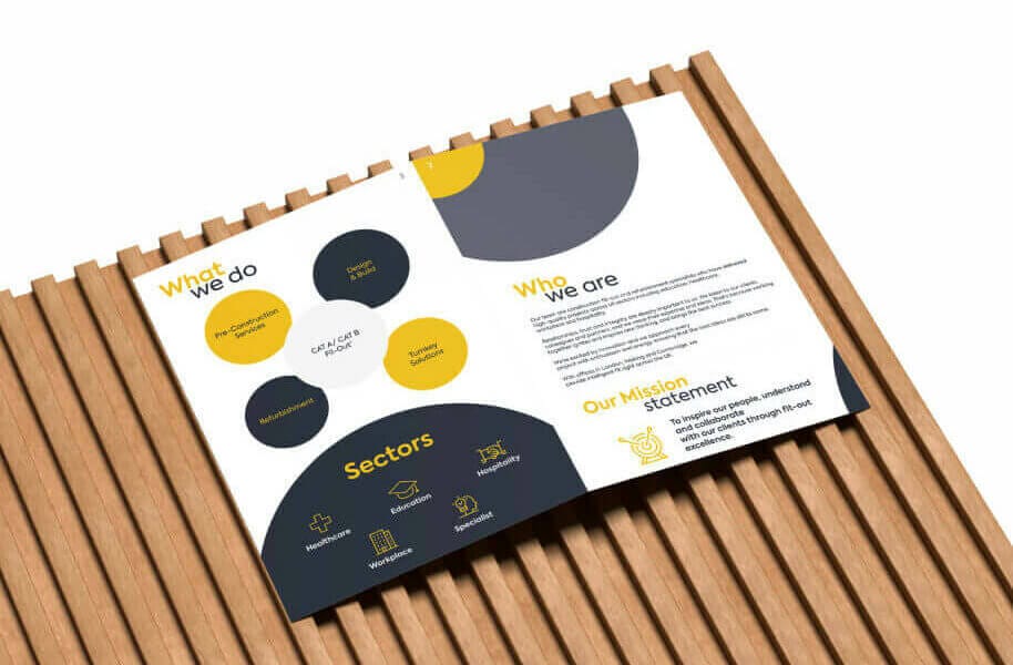 A business brochure with yellow and black circles on a wooden surface.
