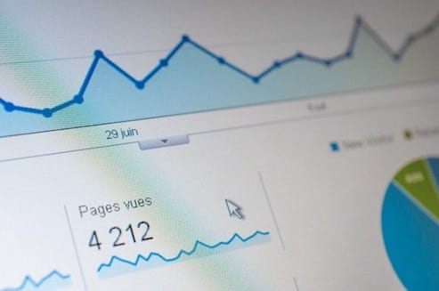 The Ultimate Guide to Building a Website in 2024, illustrated through a computer screen displaying a graph of Google Analytics.