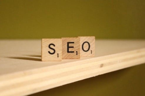 The Ultimate Guide to Building a Website with a wooden block labeled "seo" in 2024.