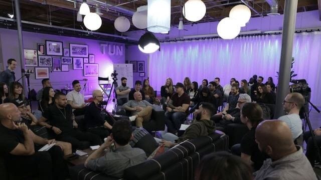 A group of people sitting in chairs in a room, celebrating Merry Christmas.